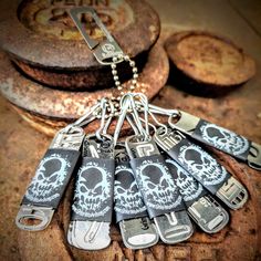 a bunch of key chains with skulls on them