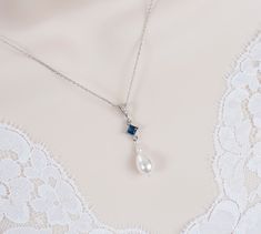 Vintage.Romantic Style.Blue Sapphire Necklace.Wedding Pearl and Sapphire CZ Bridal Necklace.Vintage Victorian Style Swarovski Pearl Necklace Materials used: - White/Ivory Cream Swarovski pearls - cubic zirconia stones - rhodium plated over brass chain - rhodium plated over brass metal connectors and bail The necklace will arrive packaged ready for gift giving in a delicate white jewelry box with a silver ribbon. Matching earrings for this necklace:  https://www.etsy.com/ca/listing/1723622924/blu Pearl And Sapphire Necklace, Swarovski Pearl Necklace, White Jewelry Box, White Jewelry, Sapphire Necklace, Swarovski Pearls, Pearl Color, Brass Chain, Star Necklace