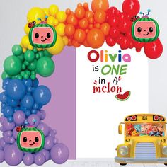 a school bus and balloon arch with the words ollivia is one in a melon