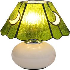 a green lamp sitting on top of a white table