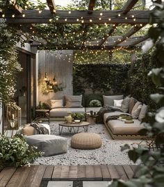 an outdoor living area with couches, tables and lights