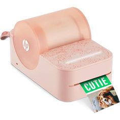 a pink printer with a cutie sticker on it's side and an image of a dog in the background