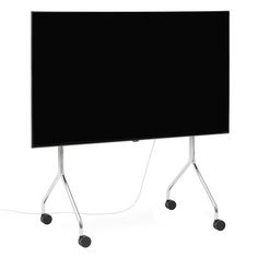 a black screen sitting on top of a metal stand next to a white wall with wheels