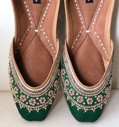 'GRACEFUL GREEN'  is an extraordinary jutti intricately hand embroidered on green  silk base with delicate kundan beads, zardosi work and gold dabka strings. Like its name, it's elegant, timeless and graceful!PERFECT FOR ANY OCCASION AND ANY OUTFIT!!Ethnic Shoes/Women Flats/Handmade Indian Designer Women Shoes or Slippers/Royal shoes/traditional style Women/Wedding Shoes/Bridal Shoes, Punjabi Jutti for WomenSPECIFICATIONS:•Upper/Panna -Fabric base embellished with white and gold beads  and zari Traditional Flats With Mirror Work For Festivals, Traditional Open Toe Wedding Shoes, Green Bohemian Traditional Wear With Dori Work, Bohemian Green Traditional Wear With Dori Work, Bollywood Style Cutdana Flats For Festivals, Bollywood Style Flat Wedding Shoes For Festivals, Traditional Flat Wedding Shoes For Festivals, Slip-on Wedding Shoes With Dori Work, Traditional Flat Heel Wedding Shoes