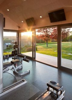 an exercise room with treadmills and sliding glass doors