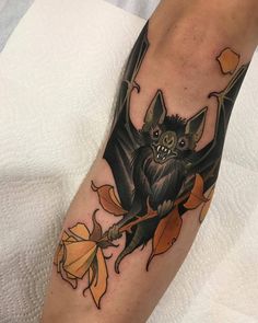 a bat tattoo on the leg of a person