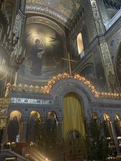 the interior of an ornate church with paintings on the walls