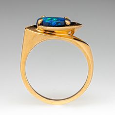 a gold ring with a blue stone in the center