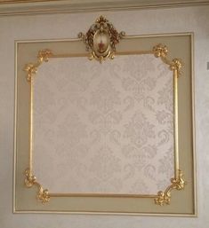 an ornate gold frame hangs on the wall