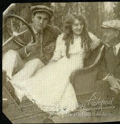 an old black and white photo of three people in a car