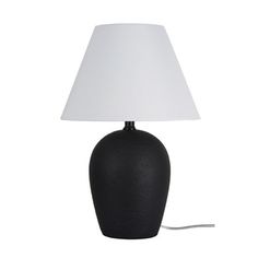 a black table lamp with a white shade on the base and a cord attached to it