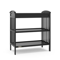 a black baby crib with two shelves on the bottom and one shelf below it