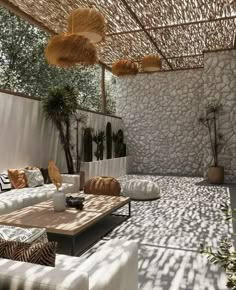 an outdoor living area with couches and tables