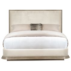 a bed with a white comforter and pillows on it's headboard, in front of a white background