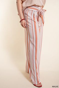 Workwear for the modern office — step up your 9 to 5 game with the One to Remember Tie Front Pants. These classic striped pants have been amped up with a smocked back and a tie front for a comfortable and stylish look. The mauve and white color combination makes them perfect for the Spring and Summer seasons, and the wide leg silhouette makes these long pants the perfect smart-casual choice. Get the perfect blend of comfort and style with the One to Remember Tie Front Pants. 100% Polyester Want Striped Wide-leg Pants With Elastic Waistband, Striped Wide Leg Trousers With Elastic Waistband, Striped Wide Leg Pants With Elastic Waistband For Work, Striped Wide Leg Ankle-length Pants With Elastic Waistband, Striped Trousers With Elastic Waistband, Striped Straight Pants With Elastic Waistband, Straight Striped Pants With Elastic Waistband, Spring Pinstripe Bottoms With Elastic Waistband, Spring Striped Bottoms With Tie Waist