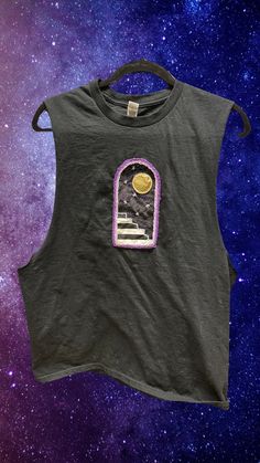 This started as a brand new black cotton Gildan t-shirt, size L. I hand embroidered the scene of the full moon portal, then added that to the T-shirt. I then embroidered the purple frame of the portal doorway onto the shirt.  Will you walk through the doorway? Cut Off Shirt Dimensions Laying Flat: Shoulder to Shoulder - 15.5" Bottom Width - 22" Arm Hole Length - 21.25" Total Length - 28" Follow me on socials! @sacralstardust @shopsacralstardust *All Clothing is freshly washed before you receive it Portal Doorway, Moon Portal, Purple Frame, Cut Off Shirt, The Portal, The Full Moon, Sleeveless T Shirt, Sleeveless Tshirt, Top Sleeveless