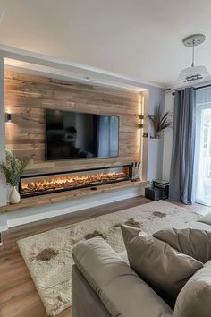 a living room with couches and a flat screen tv mounted on the wall above it