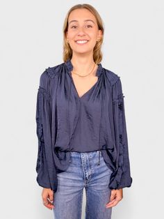 Introducing the Alessandra Top - featuring a playful v neckline and a fun ruffled collar. The tassels add an extra touch of quirkiness to this relaxed-fit top, while the balloon sleeves and ruffle details down the sleeves make a statement. Plus, the soft satin fabric adds a luxurious feel to this must-have piece. 100% Polyester Machine Wash Cold Navy Blouses, Navy Blouse, Ruffled Collar, The Balloon, Top Sales, Balloon Sleeves, Top Women, Sweater Weather, Satin Fabric