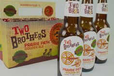 four bottles of two brothers golden ale sitting next to a box with the same label on it