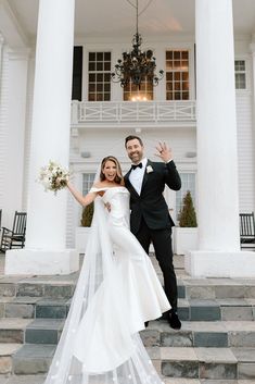 a bride and groom posing for a photo in front of a white building with columns