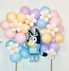 a bunch of balloons that are in the shape of an animal with a cat on it