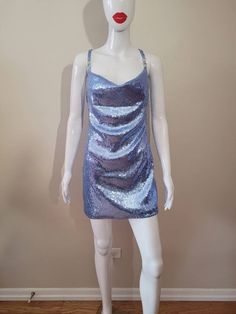 "Inspired by Dua Lipa's song \"Levitating\" It is made with a cornflower blue stretch sequin fabric. 100% lined 4 Rhinestone ornaments on the straps The skirt length from waist to hem is approximately 17\" and about 4\" above the knee (If you would like the skirt a little longer please contact me. Made to Order Sizes: Bust XS- 31-33\" Bust S- 34-36\" Bust M- 37-39\" Bust L- 40-41\" Bust Waist XS- 25-26\" waist S- 27-28\" waist M- 29-30\" waist L- 31-32\" waist Hips XS- 33-34 S- 35-36 M- 37-40 L- Light Blue Sequined Dress For Gala, Blue Embellished Sequin Dress For Summer, Blue Embellished Sequin Summer Dress, Blue Mini Dress With Contrast Sequins, Blue Dresses With Contrast Sequin For Night Out, Blue Sequin Fabric For Party Season Night Out, Blue Sequin Fabric For Party Season And Night Out, Glamorous Light Blue Party Dress, Blue Fitted Sequin Fabric For Night Out