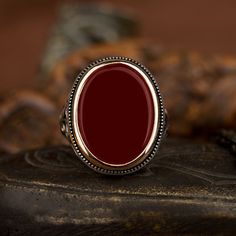 Red Agate Flat Silver Ring For Men. Handmade in 925 sterling silver with agate stone. On the ring Oval flat red aqeeq - agate, onyx stone settled. Covered with yellow color rhodium plated frame. No gold or gold plating settled. Dimensions of stone is 20 mm x 15 mm. Average weight of Red Agate Flat Silver Ring is 14 gr. (depends your ring size). Back side is closed. Classic and exclusive style. Stone Type: Aqeeq - Agate Stone Color: Red Stone Dimensions: 20 mm x 15 mm Stone Shape: Oval, Flat Aver Red Gemstone Ring Men, Luxury Red Gemstone Men's Ring, Red Round Agate Jewelry, Red Oval Cabochon Gemstone Signet Ring, Luxury Red Agate Men's Ring, Mens Ruby Ring, Silver Ring For Men, Gothic Men, Silver Men Ring