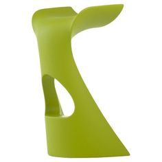 a green vase sitting on top of a white table