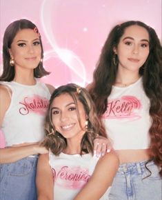 two women in white shirts and jeans posing for a photo together with the caption hello kitty