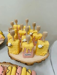 there is a cake with yellow icing on it and other desserts in the background