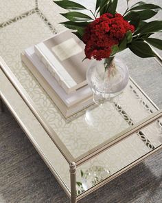 a glass coffee table with flowers on top