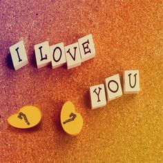 the word i love you spelled with letters on top of each other in front of an orange and yellow background