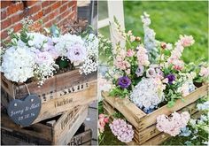 two wooden crates with flowers in them on the ground and one is filled with white and pink flowers