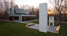 a concrete structure sitting on top of a lush green field next to a park bench