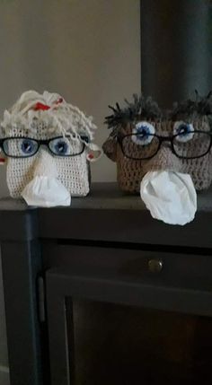 two crocheted owls with glasses on top of a dresser