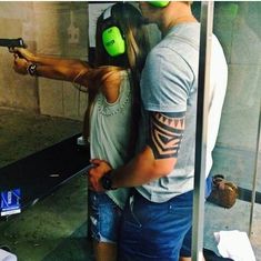 a man and woman with headphones on taking a selfie in a bathroom mirror