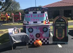 an old fashioned candy machine is on display in front of a small halloween themed building