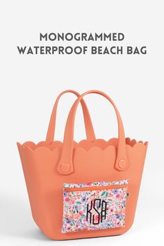 the monogrammed waterproof beach bag is shown in pink and has flowers on it