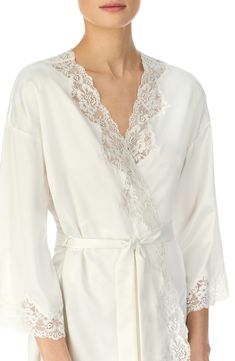 This silky satin robe takes a romantic turn with sheer scalloped lace tracing the front and sleeves. 36" length (size Medium). Ties at waist. Three-quarter sleeves. 100% polyester. Machine wash cold, tumble dry low. By Lauren Ralph Lauren; imported. Lingerie.