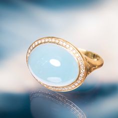 Shop Lauren K at Alchemy Jeweler in Portland Oregon | Aquamarine, 19.26 carats, 20mm x 15mm | Diamonds, 0.31 carat total weight | 18k Yellow Gold, flower impression on both sides | Ring Size: 7 Elegant Intaglio Signet Ring, Luxury Oval Moonstone Ring With Rose Cut Diamonds, Luxury Cabochon Signet Ring For Formal Occasions, Luxury Oval Cabochon Gemstone Signet Ring, Luxury Polished Moonstone Ring, Luxury Signet Ring With Oval Cabochon Gemstone, Elegant Blue Moonstone Ring For Formal Occasions, Luxury Moonstone Ring With Rose Cut Diamonds, Luxury Oval Moonstone Ring With Diamonds