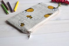 "Bees pencil case, Pencil Pouch, Cosmetic pouch, Make Up Pouch, Charger bag, Project bag, Travel bag, Bridesmaid gift, Bridal purse, Toiletery bag, Bridal clutch You can carry and any other sorts, like cosmetics, pencils or whatever you see fit. *If you want other size or fabric contact me via Etsy conversation length - 3.5\" (9 cm); width - at the zipper top 7\" (17 cm); width - 7,6\" (19,5 cm). Exterior fabric: beige, black, yellow, white* linen 58 %, cotton 42 % (the print placement on the fa Canvas Pencil Case Design, Pencil Pouch Design, Beige Pencil Case With Pen Slots, Beige Pencil-shaped Pencil Case For School, Beige Pencil Case With Pen Holders, Cotton Pencil Case With Pen Holders As Gift, Beige Pencil Case With Pen Holders As Gift, Beige Pencil Case With Zipper As Gift, Beige Zipper Pencil Case As A Gift