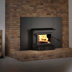 a brick fireplace with a fire burning in it