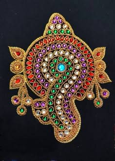 an intricately designed brooch with colorful stones