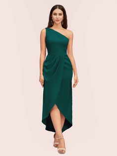 a woman in a green dress with one shoulder draped over the top and an asymmetric