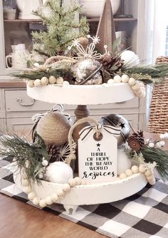 a three tiered tray with christmas decorations on it and a sign that says there is no place like home