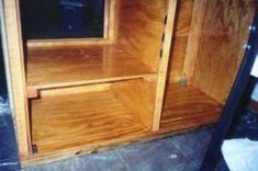 a wooden shelf with a mirror on it in a room that is being remodeled and remodeled