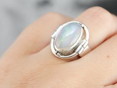 "We've taken one of our beautiful Ethiopian opals and set it in a shining statement ring. Crafted of sterling silver, this piece is simple, with a highly polished bezel that makes a perfect reflective frame for the opal. The gem is translucent, filled with orange and green fire and flash. Metal: Sterling Silver Gem: Ethiopian Opal Gem Measurements: 13.4 x 8.6 mm, Oval Ring Size: 5.75 Marks: \"925\" Stamped on the inside band SKU #: HYJC37V5 Each piece has been identified and graded by a Graduate Oval Opal Ring, Beautiful Ethiopian, Yellow Gold Sapphire Ring, Opal Ring Vintage, Sterling Silver Opal Ring, Silver Opal Ring, Green Fire, Ring Opal, Cameo Ring