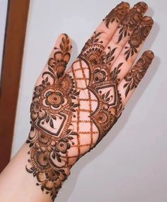 a woman's hand is decorated with hennap and intricate designs on it