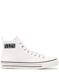 Keep it casual but never boring. Crafted from cotton, these black and white high-top sneakers from Valentino Garavani are decorated with a VLTN logo patch to the side and logo-printed laces. The perfect choice for an unapologetically cool relaxed look. Featuring a round toe, a lace-up front fastening, a brand embossed tongue, a pull tab at the rear and a branded rubber sole. Valentino Garavani Shoes, Hightop Sneakers, White High Tops, Chuck Taylor Sneakers, Pull Tab, Converse High Top Sneaker, Converse Chuck Taylor High Top Sneaker, Sneakers White, Golden Goose Sneaker