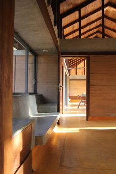 the inside of a house with wooden walls and flooring is lit by sunlight coming through windows